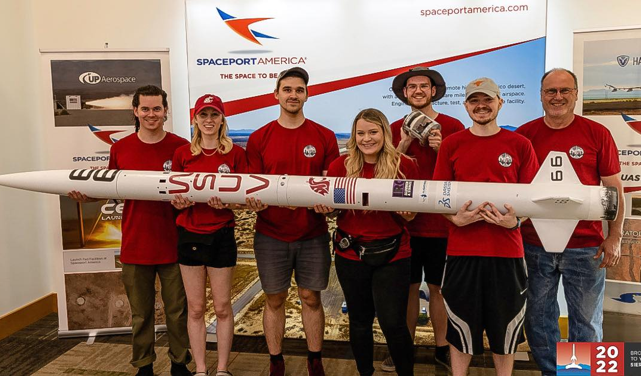WSUV ENCS Aerospace club students holding their 10 foot long rocket